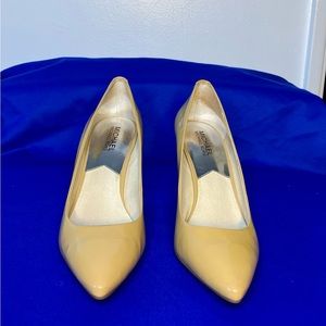 This is a pair of Michael Kors bone color closed toe pumps, worn twice.